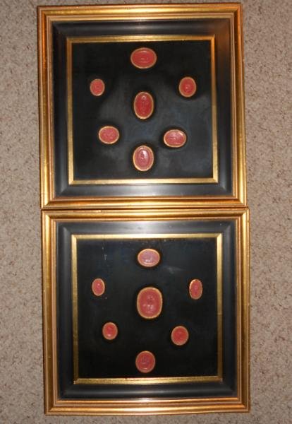 COLLECTION OF ANTIQUE RED WAX INTAGLIOS: Fourteen round and oval pieces, showing assorted figures with some animals, held within two shadow boxes.