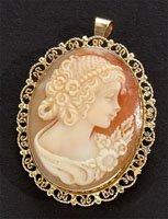 CAMEO PENDANT BROOCH: 14k yellow gold brooch set with one shell cameo. Brooch measures 1 1/2 x 1 1/8 inches and has a hidden swivel bale. 6.5 grams.
