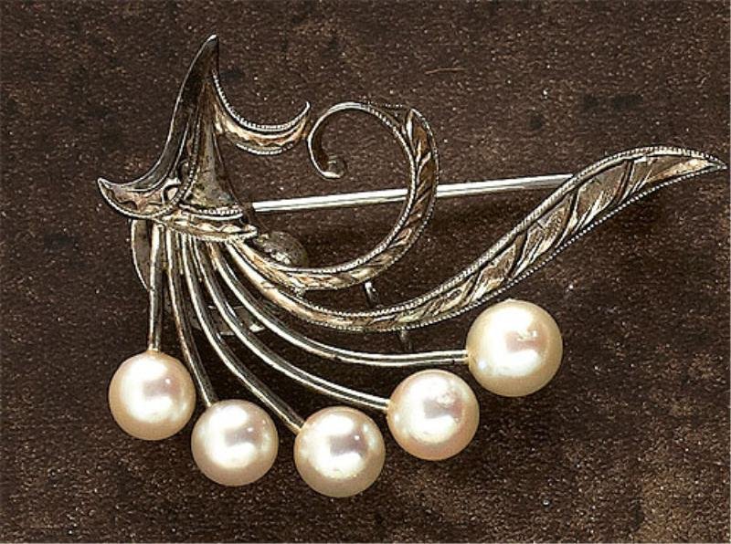 PEARL BROOCH MIKIMOTO: Sterling silver brooch with a spray of cultured pearls measuring 5-5.5mm. Brooch has signature "M" hallmark. 1 1/2 x 1 1/8 inches.