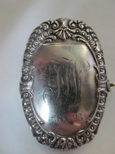 STERLING SILVER MATCH SAFE: Oval shape with scrolling trim, equestrian decorated with a horse head profile inside a horseshoe, the obverse monogrammed and dated "98".