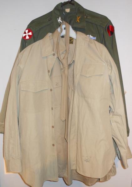 COLLECTION OF U.S. MILITARY CLOTHING: Consisting of a field jacket with red cross to left sleeve, a Vietnam era 8th Army shirt(patches possibly late addition), two tan khaki dress shirts and a tan tie.