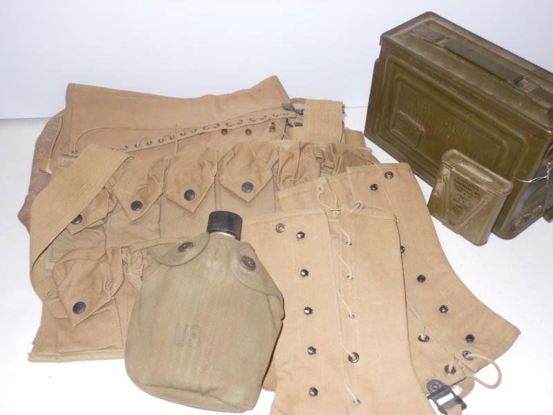 TEN MILITARY ITEMS: Consisting of a Canco M1 30 caliber ammo box, pair of Diamond Brand tent straps, M1 belt pouch, WW2 canteen with cover, M5 eye ointment tin, two pair of WW2 era canvas leggings, vintage pair of tan co