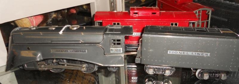 LIONEL O GAUGE TRAIN SET: Ten cars consisting of Engine no 265-E (Commodore Vanderbilt) locomotive with 265W tender, #2816 hopper, #2812 Gondola, #811 flatcar with lumber, #815 Sunoco tank car, #813 stock car, #814 boxcar, #81