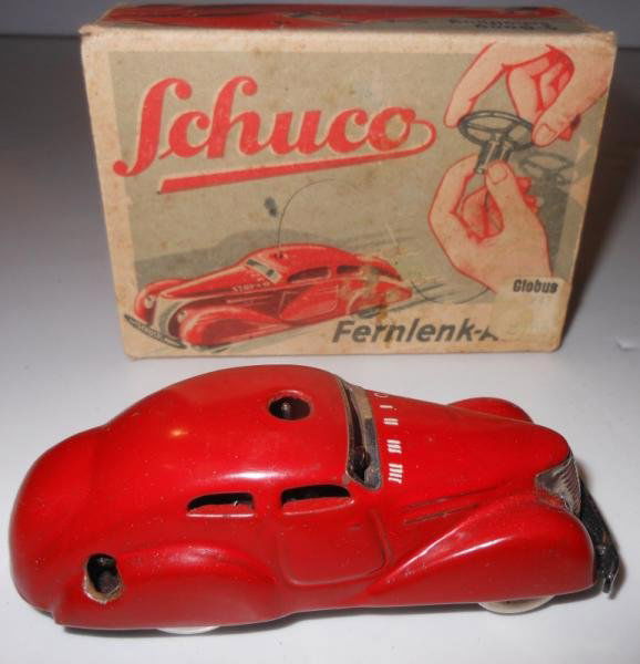 SCHUCO 3000 FERNLENK-AUTO: Red tinplate clockwork car in original box with accessories and instructions.