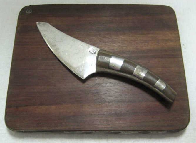 WILLIAM SPRATLING, TAXCO, MEXICO: Two-piece sterling silver and rosewood cheese set, a cutting board and knife, circa 1950.