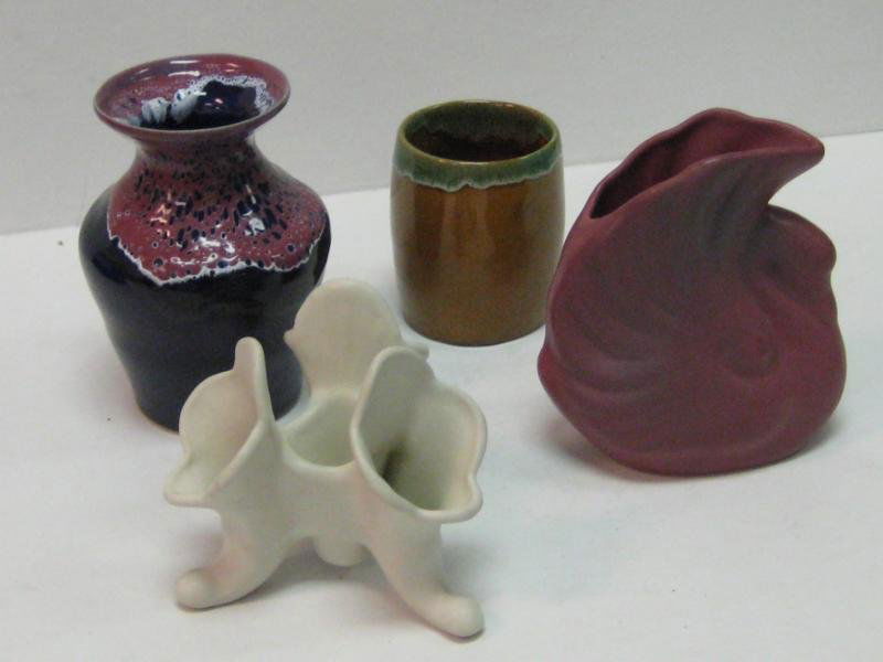VAN BRIGGLE, COLORADO SPRINGS, COLORADO: Four assorted pieces and finishes, including a mauve to cobalt drip glaze vase, 6 in.; triple cornucopia vase in white, 4 5/8 in.; mulberry swan, 6 in,; and a green drip to brown cup, 3 7/8 in.
