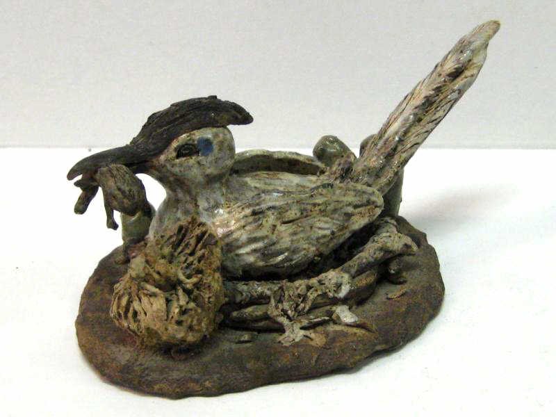 CONTEMPORARY STONEWARE FIGURE: Long-tail bird in nest, holding frog in its beak, impressed MARTIN. 5 1/4 x 11 x 7 inches