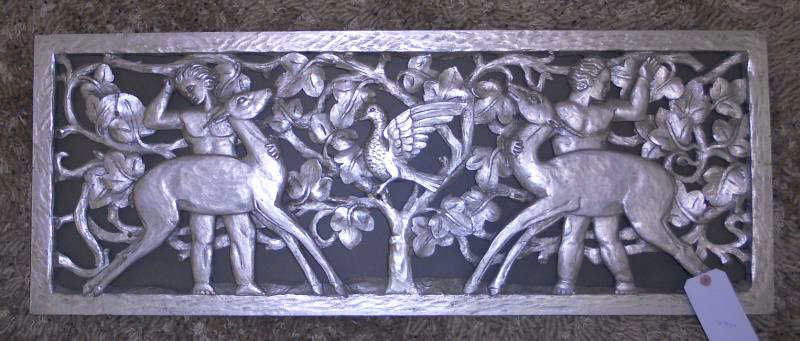 MID-CENTURY CARVED WOOD PANEL: Depicting nude males with deer and central bird, tree branch and floral background, painted silver. 14 1/2 x 38 inches