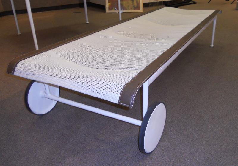 RICHARD SCHULTZ, FOR KNOLL: 1966, contour adjustable roll around lounge chair with a white aluminum frame and vinyl seat. l: 75".