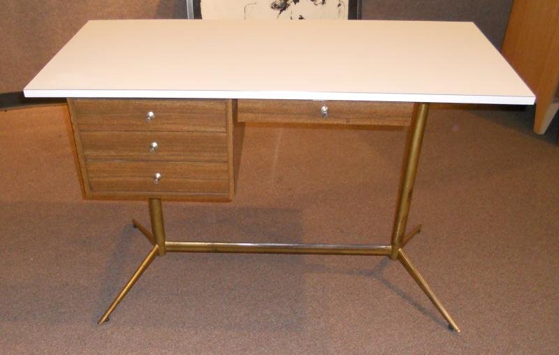 IN THE MANNER OF PAUL MCCOBB: Desk having white laminate top, single drawer over stack of three drawers, on gilt tubular metal frame. 30 x 23 x 47 inches