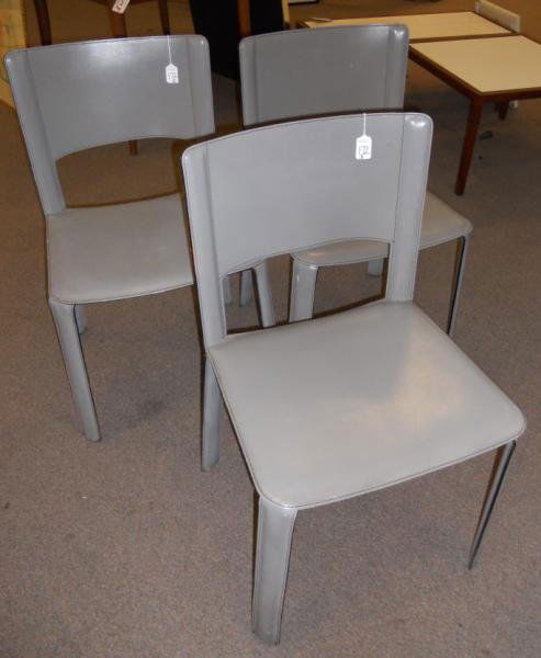 CIDUE, ITALIAN: Set of three grey leather side chairs.