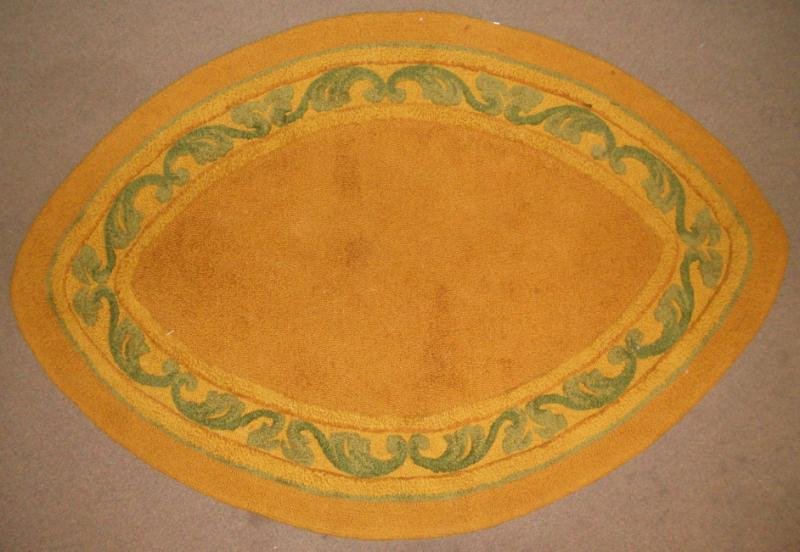 V'SOSKE ELLIPTICAL THROW RUG: Open ochre field, with scrolling green border on yellow. 4 ft. 5 in. x 6 ft. 7 in.