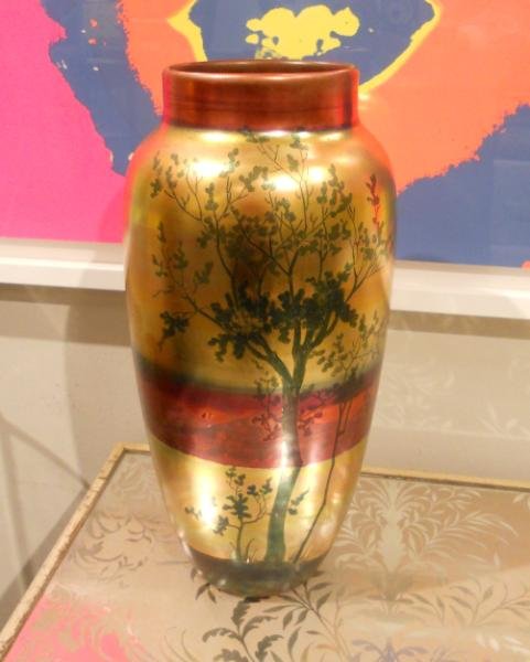 WELLER LASA POTTERY VASE: Handpainted showing trees and rolling hills at sunset, in shades of gold, red and green, signed in arched gilt ink under foot. Height 14 1/4 in.