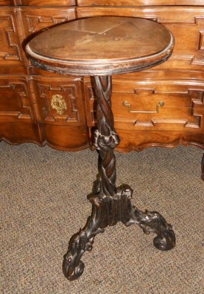 ANTIQUE AMERICAN NATURALISTIC PLANT STAND: Black Forest style, with circular top on the braided and spiraling naturalistic form pedestal support, on three downward scrolling foliate legs. Height 25 1/2, diameter 11 1/2 in.