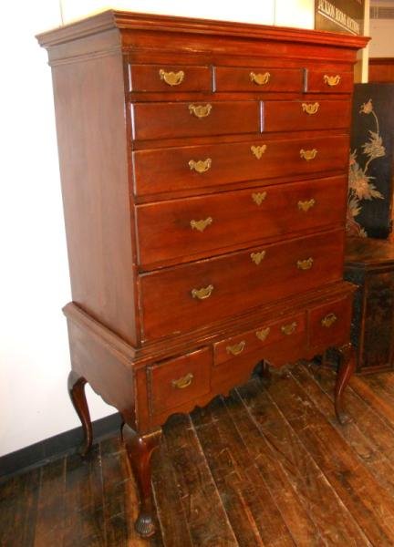 ANTIQUE AMERICAN MAHOGANY HIGHBOY: Flat top to the top member with three short, over two short and three long graduated drawers, resting on the base with three short drawers over the rolling apron, on cabriole legs ending with fluted p