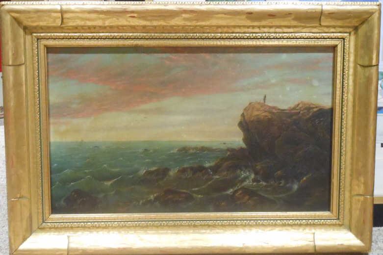 EARLY 20TH CENTURY, AMERICAN: Sunset along a rocky coast, with figure standing atop a cliff, oil on canvas, unsigned, in a carved gilt frame. 12 x 20 inches
