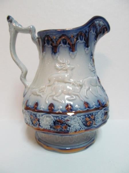 ENGLISH FLOW BLUE LUSTER JUG: Deer scene in relief, copper gold highlights, 19th/20th century. Height: 7 inches
