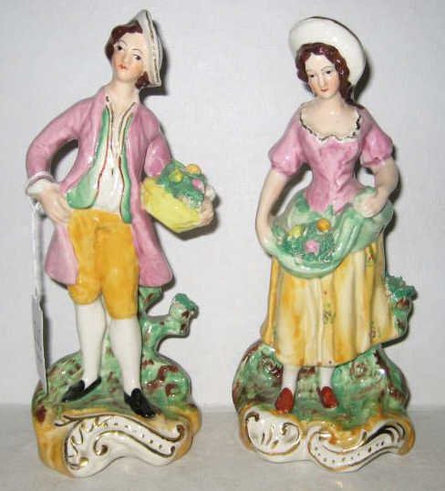 PAIR ENGLISH STAFFORDSHIRE FIGURES: Man and woman collecting flowers and fruit, both hand painted, marked underfoot "Staffordshire Ware W&K". Height: 7 1/2 and 7 3/4 inches