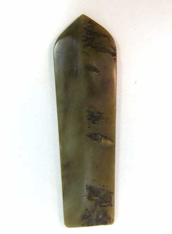 JADE SPEAR SHAPED PLAQUE: Green stone plaque with seven etched circles and wave motifs. Dimensions: 7 x 2 inches