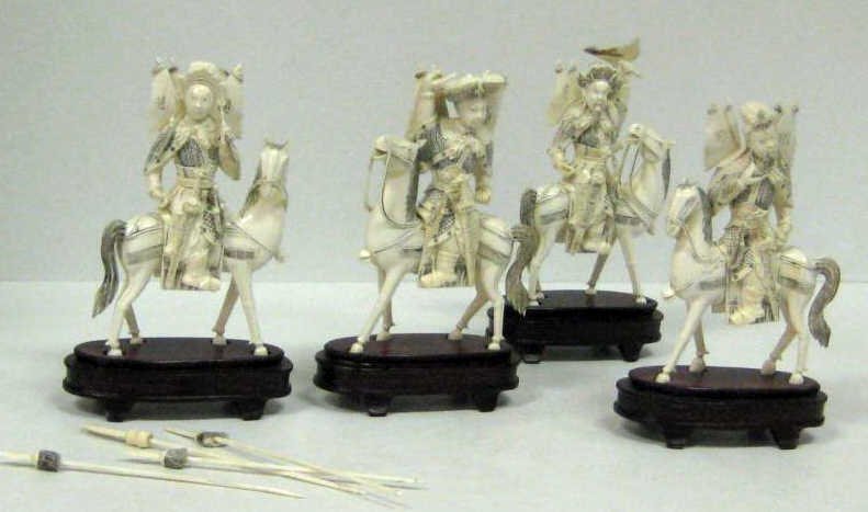 FOUR CHINESE IVORY IMPERIAL MOUNTED WARRIORS: Four mounted warriors in imperial dress with swords, spears and flags boasting respective Chinese characters. Height: 6 1/4 inches
