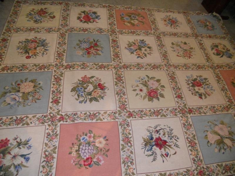 NEEDLEPOINT GARDEN PANEL DESIGN RUG: Floral bouquets center each of the red, blue and beige panels, each separated by colorful flowering vines. 9 ft. 10 in x 13 ft. 2 in.