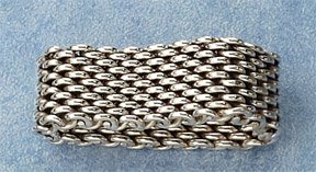 CHAIN RING, TIFFANY & CO.: Sterling silver flexible chain ring. Width 10.5mm. Size 8.