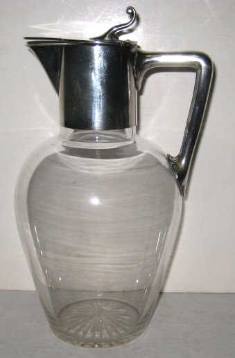 HORACE WOODWARD & CO., BIRMINGHAM & LONDON: Sterling silver mounted leaded glass jug with hinged lid and angular handle, bearing hallmarks of Edgar Finley & Hugh Taylor, London, 1889. Height 9 in.