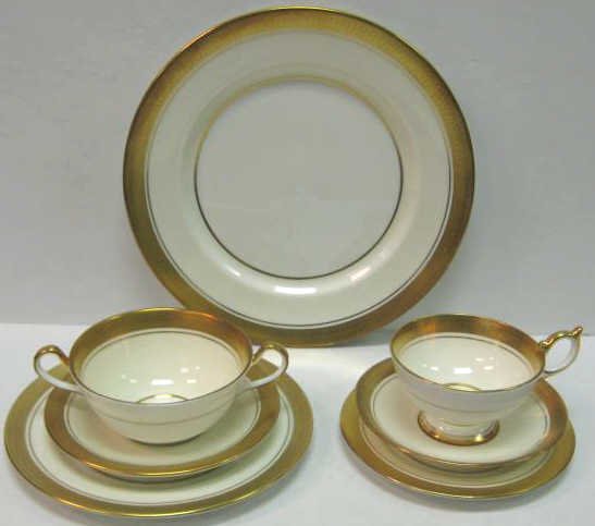 AYNSLEY PORCELAIN 'SANDRINGHAM' DINNER SERVICE: Gilt encrusted rims, comprising 12 dinner plates, 11 salad plates, 11 bread/butter plates, 11 cups and 12 saucers, 7 cream soup cups and 7 saucers, total 71 pieces.