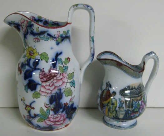 TWO IRONSTONE JUGS: Davenport flow blue with Imari style floral decoration and small creamer with printed Chinoiserie scenes. Heights 7 and 4 1/4 in.