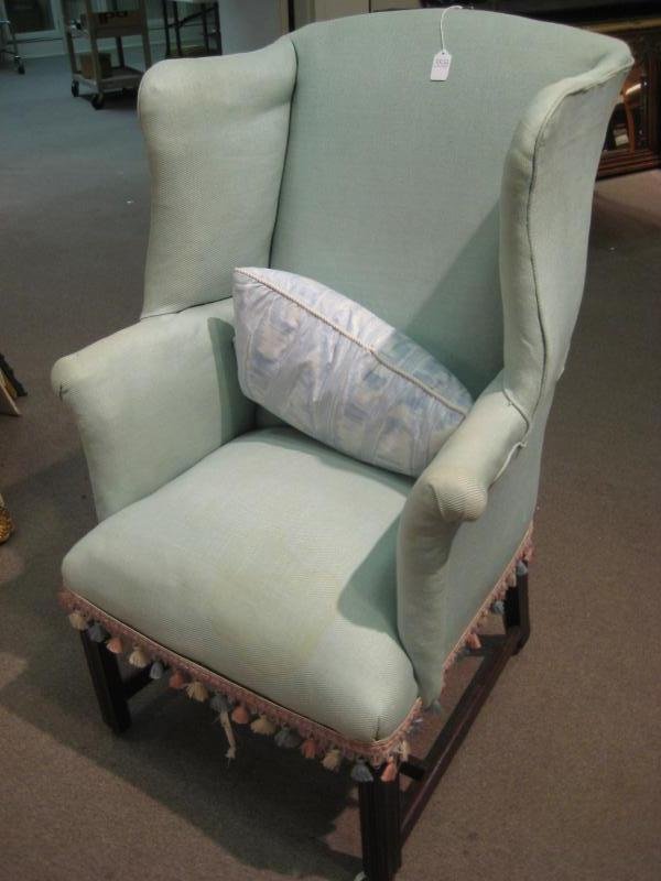 ENGLISH 18TH/19TH CENTURY WINGBACK ARMCHAIR: Mahogany straight chamfered legs connected by stretchers to the narrow bombe form body. Height 42, width 26 in.