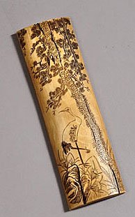 ENGRAVED IVORY WRIST REST: Finely engraved on convex side with pine tree and crane, 19th century. 6 7/8 x 2 in.
