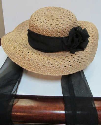 LADIES SUN HAT: Straw hat with black chiffon ribbon retailed by Saks Fifth Avenue.