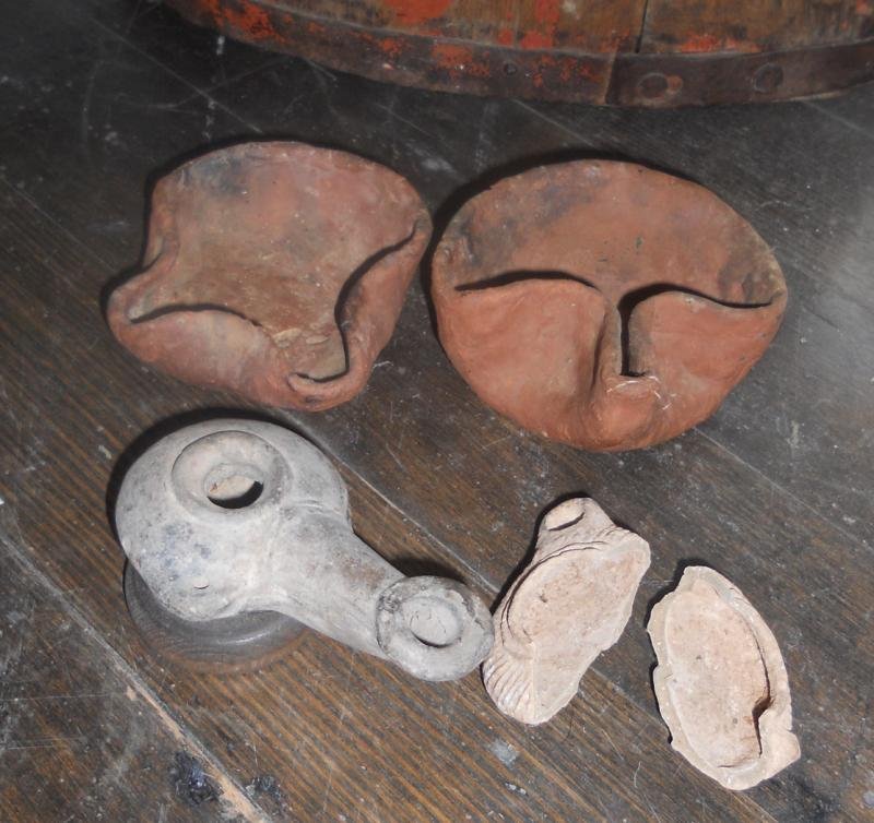 FOUR ANTIQUE EARTHENWARE OIL LAMPS: Two likely Judaic ancient pieces, and two others (one broken).