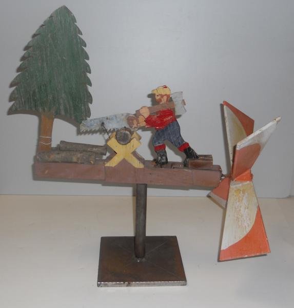 VINTAGE AMERICAN FOLK ART WHIRLIGIG: Lumberjack sawing wood. Height 23. in., length 21 in.