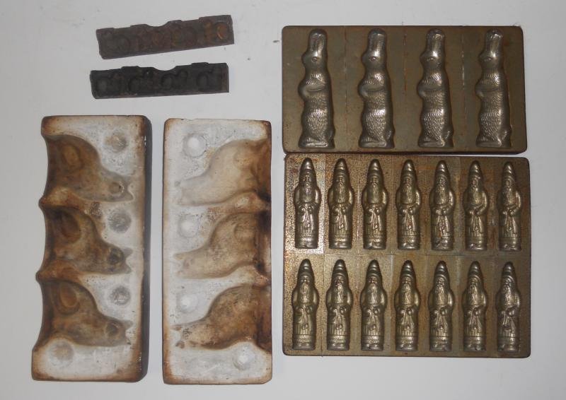 FOUR FOOD AND CANDY MOLDS: Metal 14 Santa mold, 4 rabbit mold and small iron two part animals, with a two part chalk ware 3 cat mold.