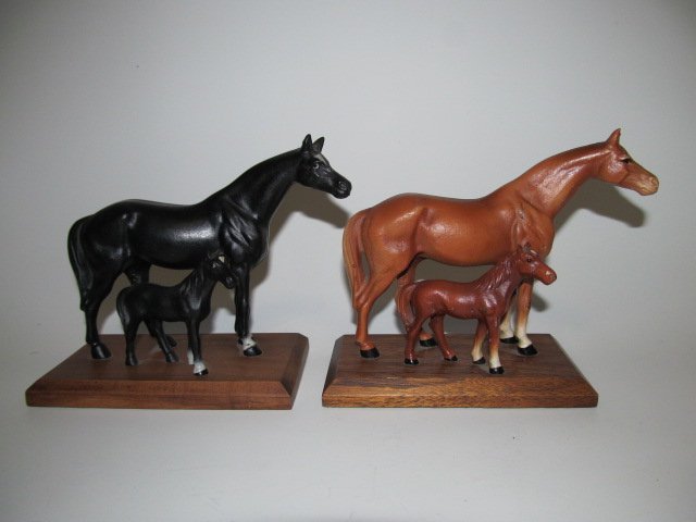 TWO HUBLEY MARE AND FOAL DOORSTOPS: Cast iron horses on wooden bases, circa 1940's, h. 5 1/2", w. 7 1/2", d. 3 1/4".