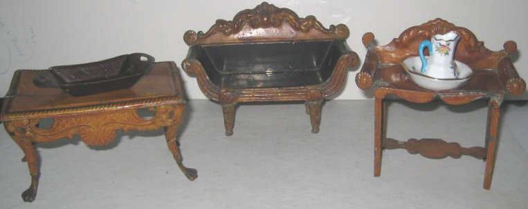VINTAGE PAINTED METAL DOLLHOUSE FURNITURE: Shell and scroll chased relief in French style comprising parlour sofa, side table and matching washstand with two-piece English porcelain chamber set and two handled tea tray, total6 pieces.