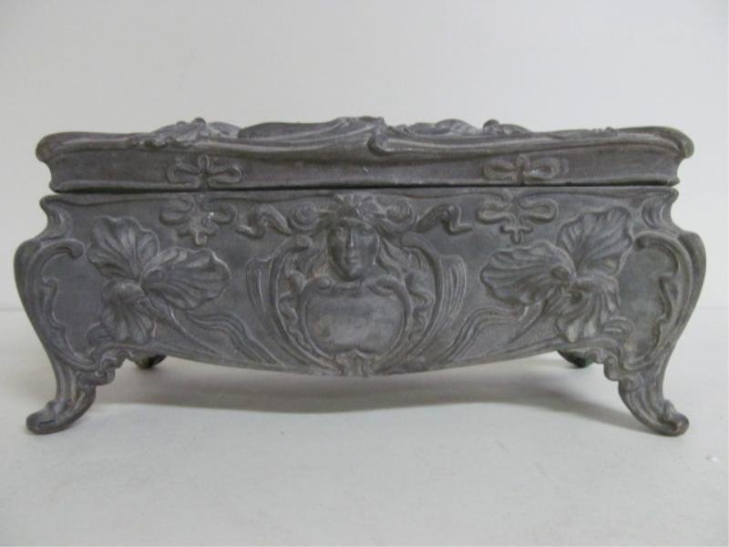 ART NOUVEAU JEWELRY / TRINKET CASKET: Smelter box with rectangular hinged lid featuring a woman with flowing hair and floral design. Height 4 in., width 3 1/2 in., depth 9 inches.
