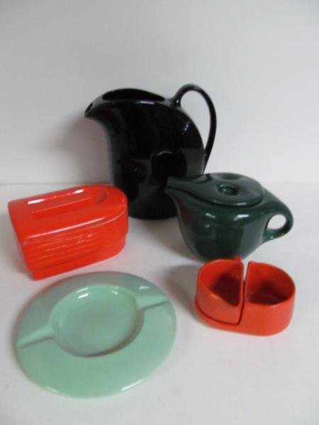 FIVE PIECES OF AMERICAN ART POTTERY: Russel Wright 'IROQUOIS' green glazed teapot, Tudor orange glazed two-piece cream/sugar set with unmarked black pitcher (h: 9 1/4 in.), lime green ashtray and Hall China for Westinghouse orange/red co