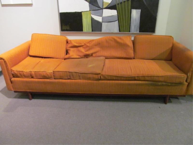 FRANK LLOYD WRIGHT FOR HERITAGE HENREDON: Sofa having Taliesin designed edges with worn orange upholstery Height 28, width 97, depth 33 1/2 in.