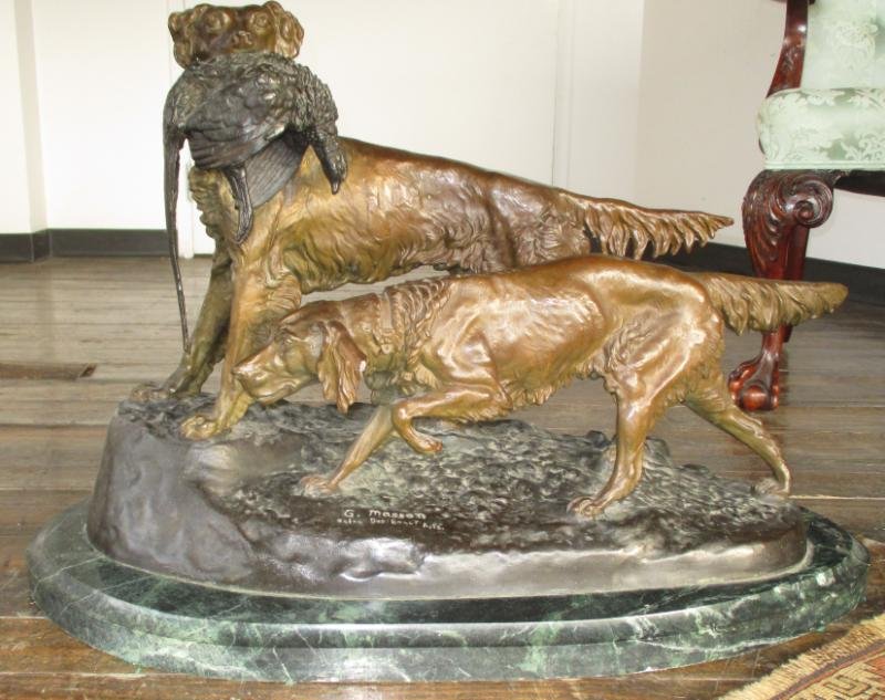 AFTER CLOVIS MASSON: Large bronze sculpture of two hunting dogs, signed to the front side "C. Masson" with "Salon des Beaux Arts" below, dogs with gilt patina, on the brown patina naturalistic ground, and green marble bas