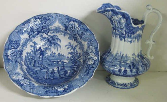 EARLY STAFFORDSHIRE BLUE AND WHITE WASH SET: Two-piece set, water pitcher (11") and wash bowl (13"), printed Arabian Scene with figures, one riding a camel, similar to MEDINA pattern, circa 1840.