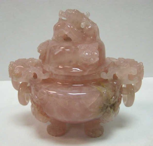ROSE QUARTZ THREE-FOOTED LIDDED JAR: With finely carved Fu dog heads, pierced detailing at handles and on lid. 6 x 6 1/2 x 4 1/2 in.