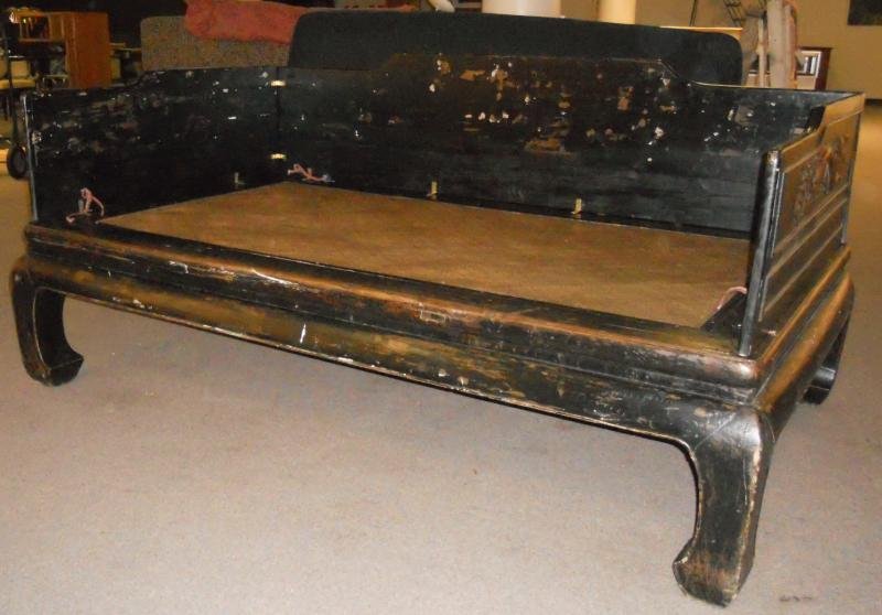 OPIUM BED: Soft woven wicker inset top, with carved wooden and lacquered 3/4 low gallery surround, decorated with dragons. Dimensions 89 x 53 x 42 in.