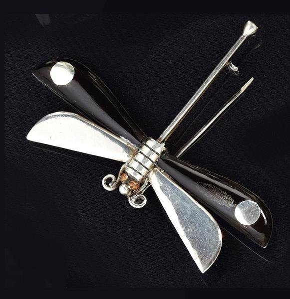 DRAGONFLY PIN, SPRATLING, TAXCO, MEXICO: Sterling silver brooch/pin in the form of a dragonfly with wooden wings. Hallmarked William Spratling, Taxco, Mexico 925. 2 inches x 2 5/8 inches. 9 grams.