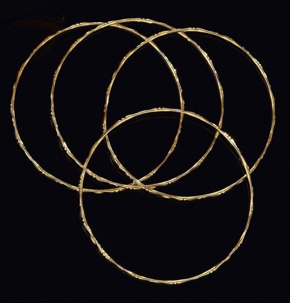 GOLD STACK BRACELETS (4): 18k yellow gold bracelets with stars and moon and beaded trim. Small size. 22.4 grams.