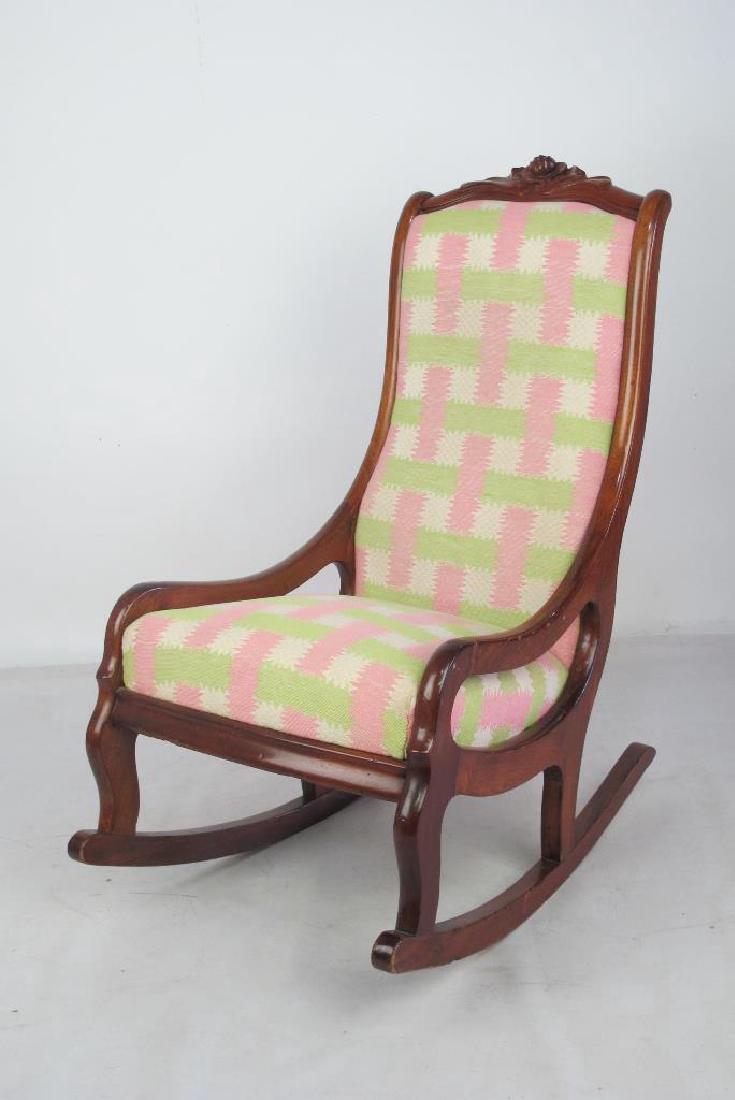 Pastel Rocking Chair: Rocker having wood frame with pastel green and pink upholstery to seat and back. Carved rose detail to top. 36 inches height, 20 inches width, 29 inches depth. 36"H x 20"W x 29"D Measurements: 36"H x 
