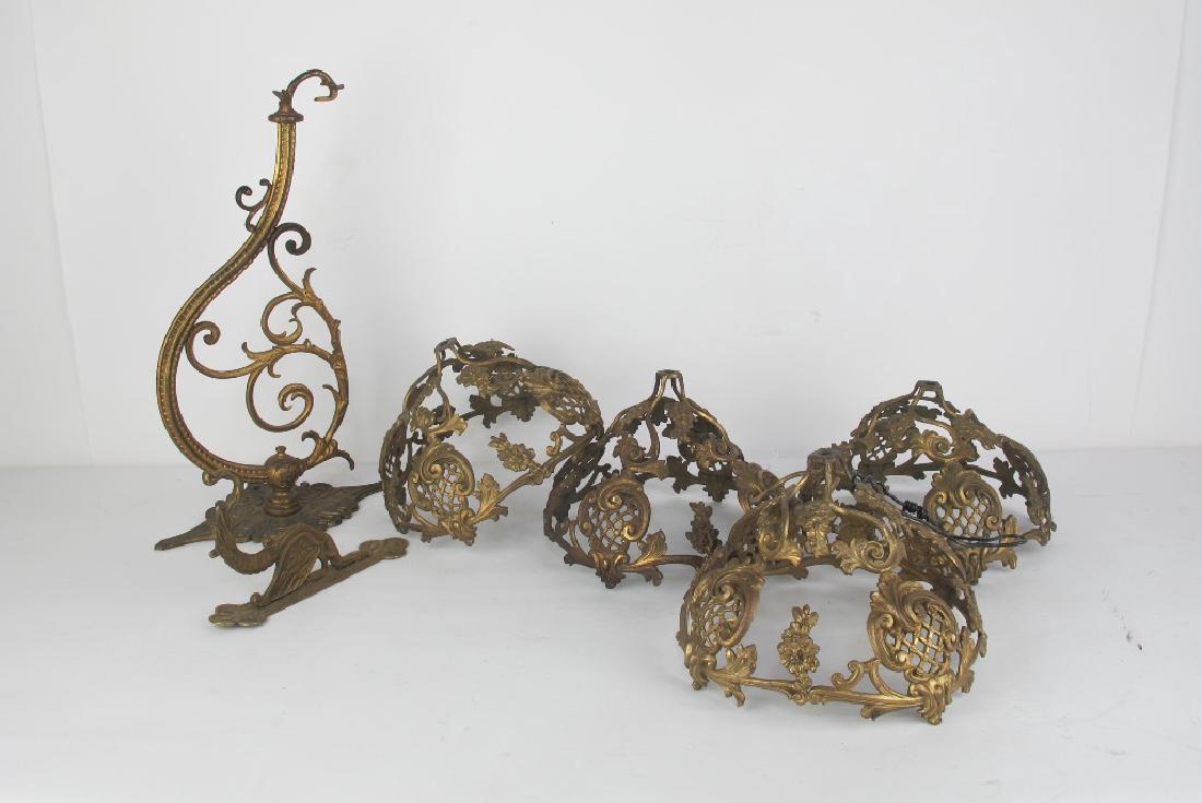Lot of Gilt Bronze Shades and Hooks: Grouping of 4 gilt bronze shades having foliate design. Also including hooks. Various sizes. Various Measurements: Various Notes: Please carefully read our terms of sale, shipping pick up information,