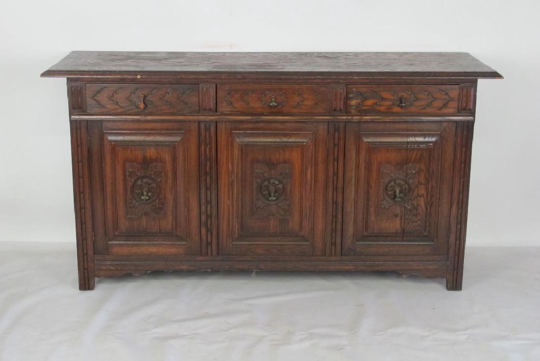Carved Side Board: Wood sideboard having 3 cabinet doors and 3 drawers with dovetail construction and metal hardware. Carved with foliate motif throughout. 35.5 inches height, 67.5 inches width, 20 inches depth. 35.5"H 