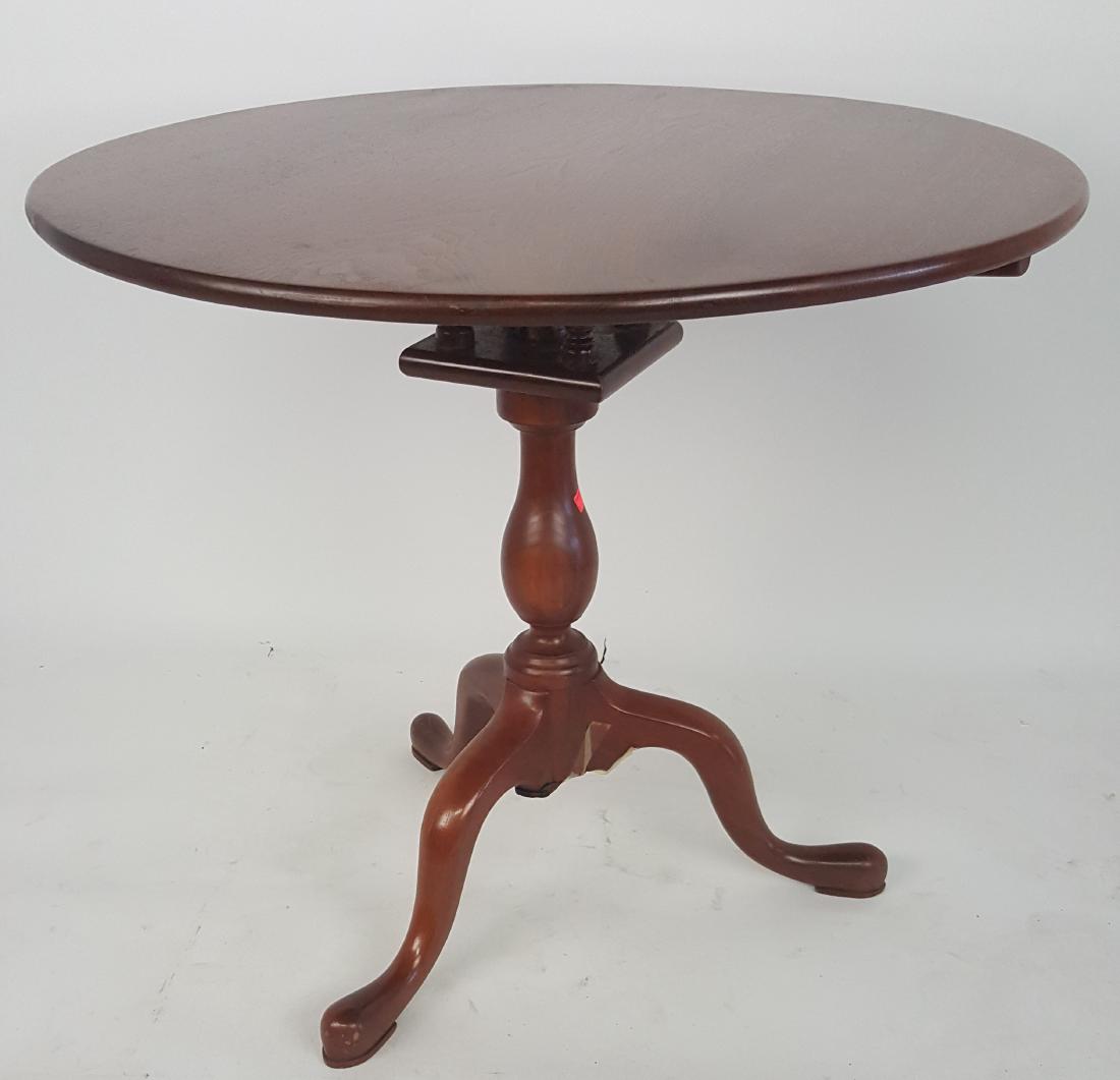 Tea Table: Round top table having pedestal base with 3 legs and carved support peg detail. Light scratches. 28 inches height, 32.25 inches diameter. 28"H x 32.25"W x 32.25"D Light scratches